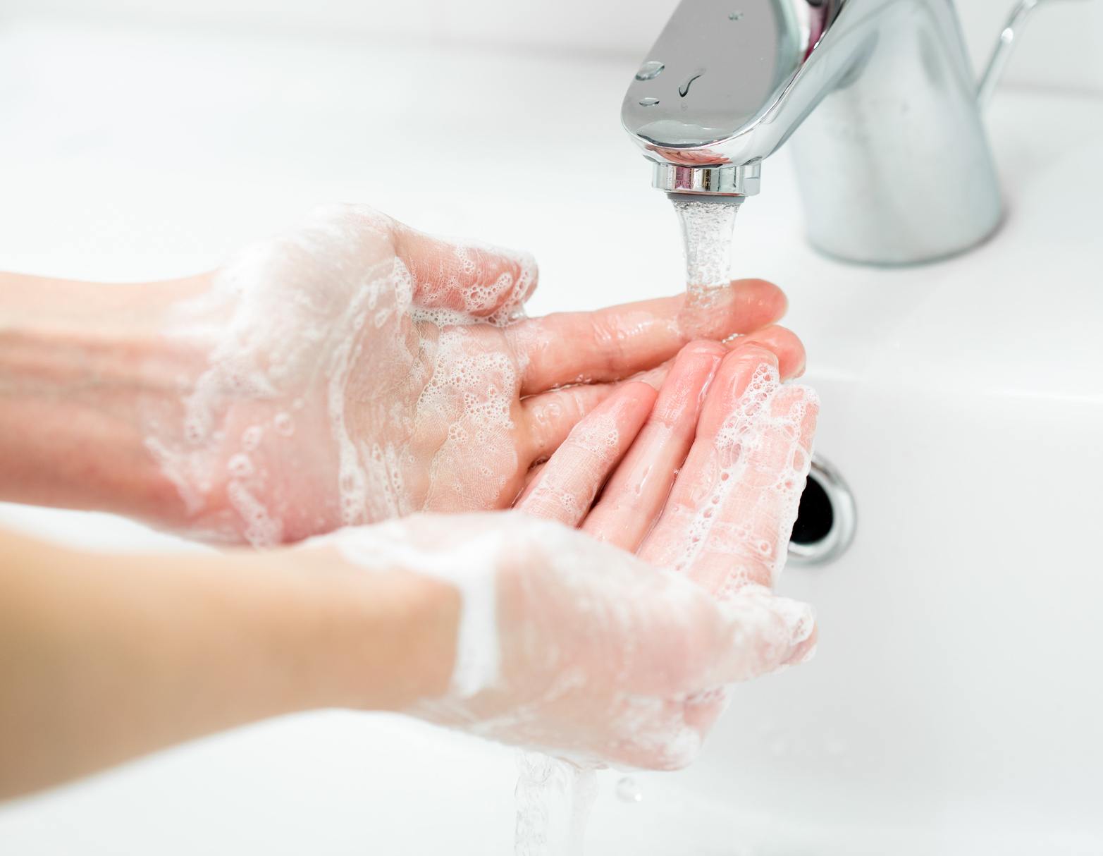 Washing of female hands with soap in bathroom close up Promocja Gojo Purell